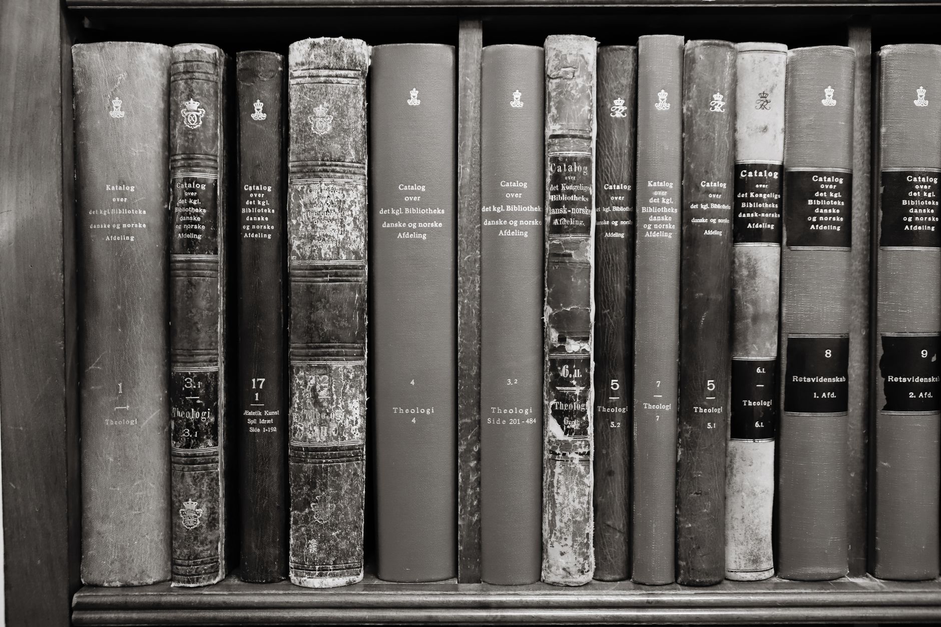 A collection of vintage books on a shelf, showcasing classic literature and history in a library setting.